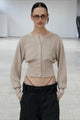 Women's cropped button cardigan with long sleeves and embroidered chest motif