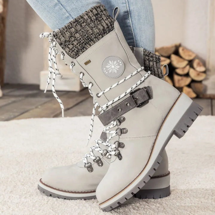 Women's lace-up snow boots with buckle straps and treaded soles