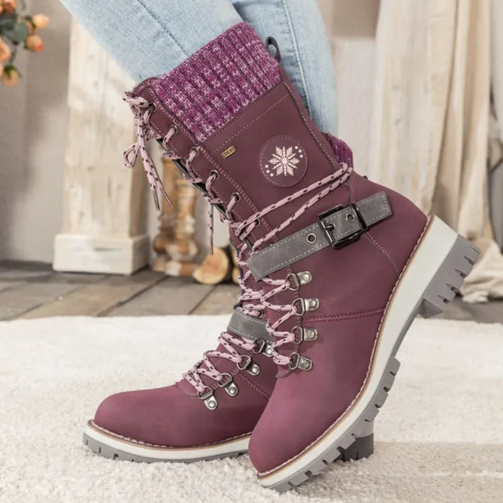 Women's lace-up snow boots with buckle straps and treaded soles