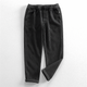 Men's ribbed corduroy pants with tapered legs and cuffed hems