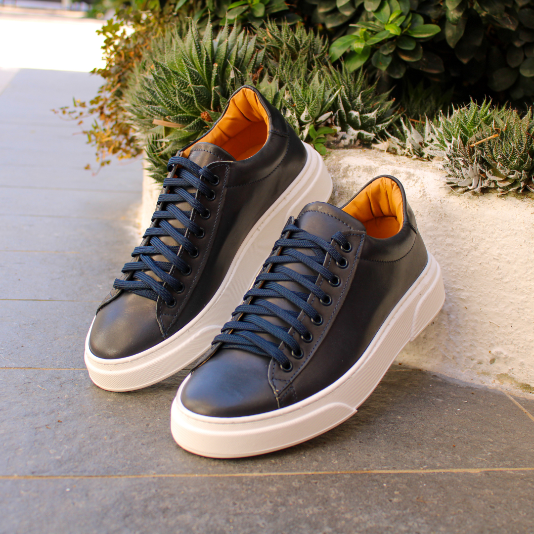 Black low-top lace-up sneaker with white platform sole