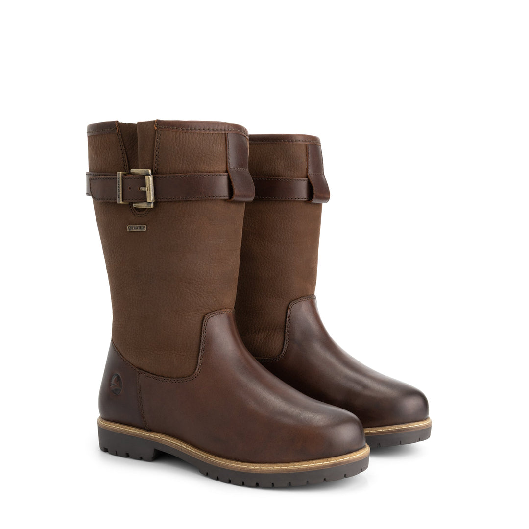 Brown tall outdoor boots with buckle straps and flat lug soles