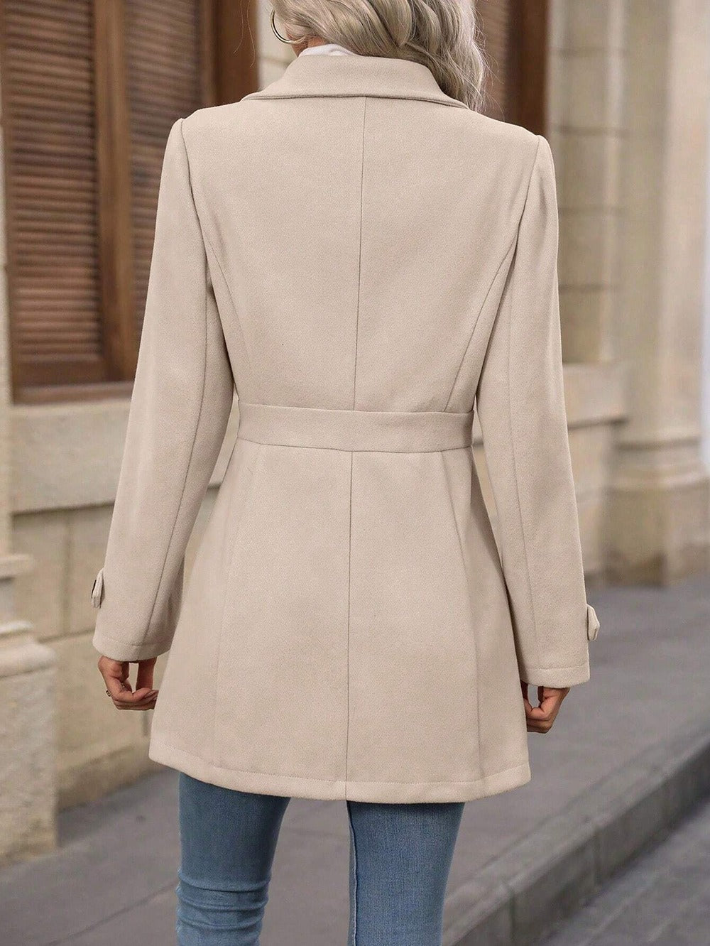 Women's tailored belted trench coat with notched lapels and long sleeves