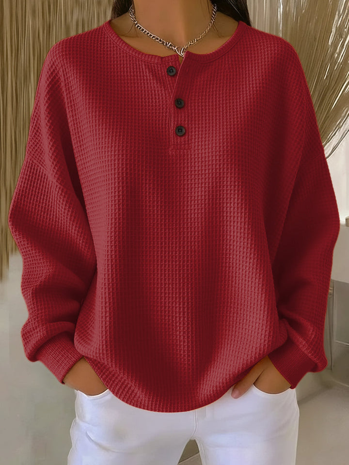 Women's long-sleeve waffle henley top with round neckline and button placket