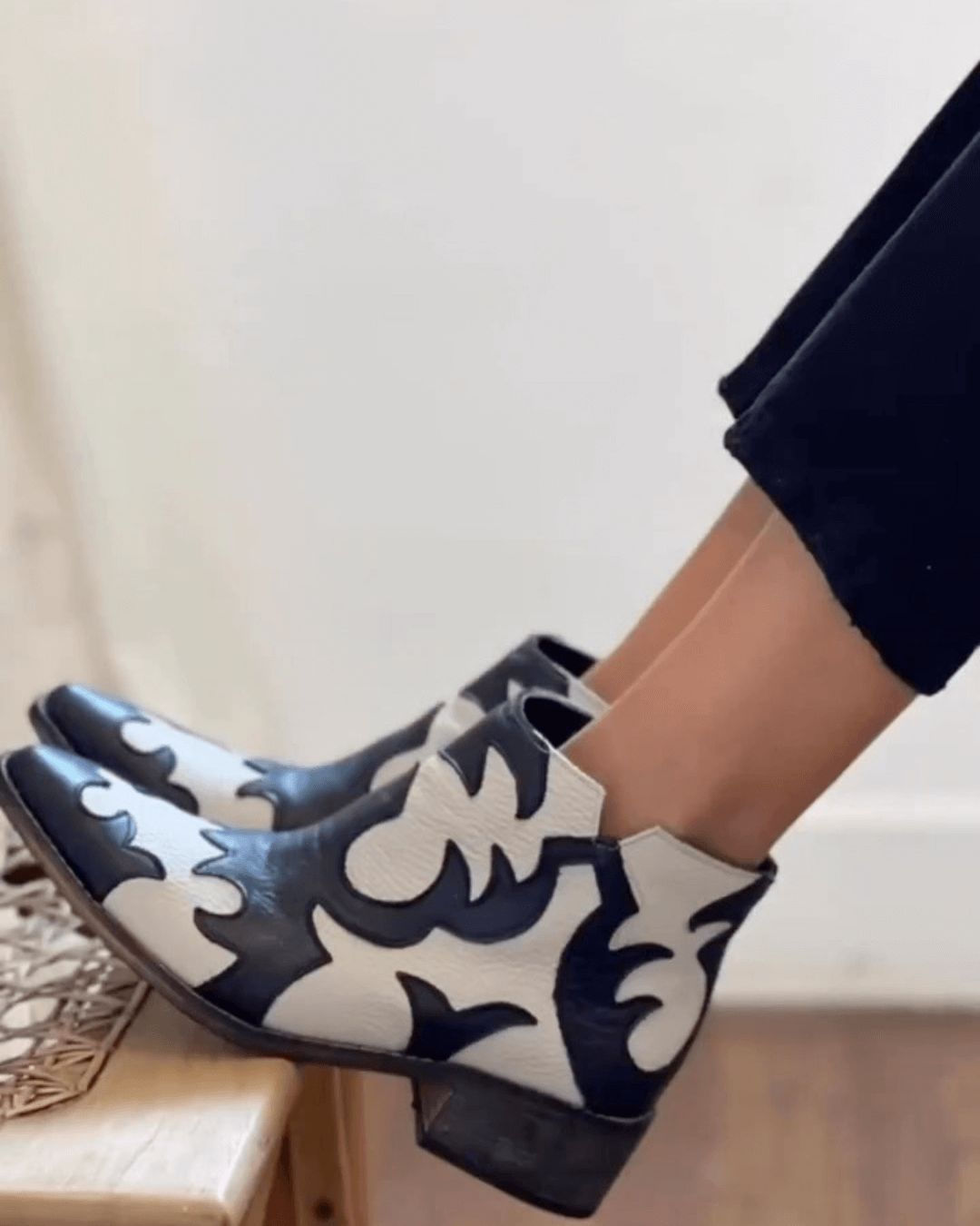 Black and cream patterned cutout ankle boots with pointed toes and low block heels