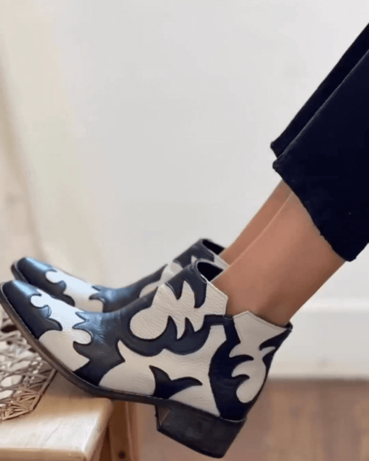 Black and cream patterned cutout ankle boots with pointed toes and low block heels