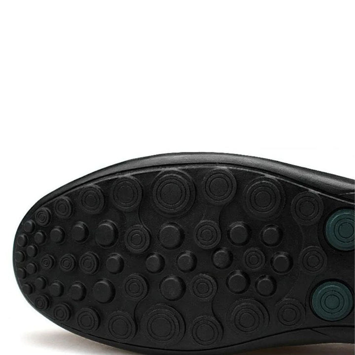 Men's slip-on loafers with stitched front detail and flat textured soles