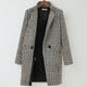 Women's black and white checked long coat with standing collar and button fastening