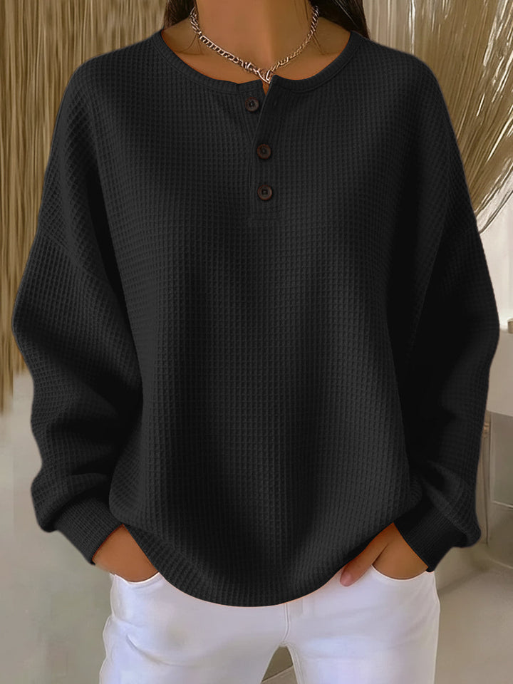 Women's long-sleeve waffle henley top with round neckline and button placket