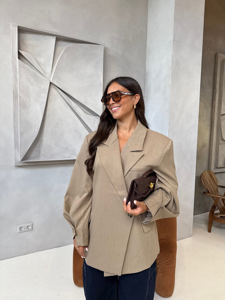Women's beige blazer with notched lapels and button cuffs