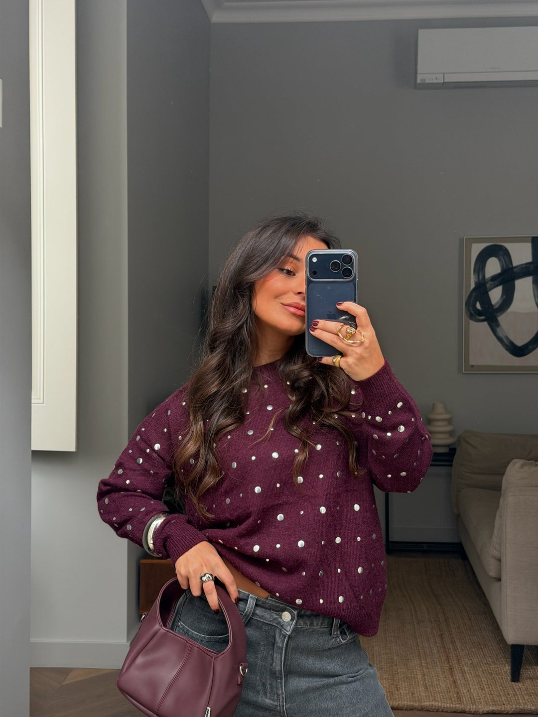 Women's burgundy crew-neck sweater with silver stud detailing and long sleeves