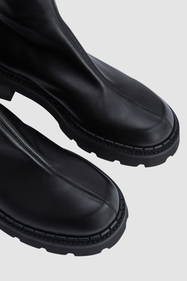 Black ankle boots with chunky block heels and lug soles