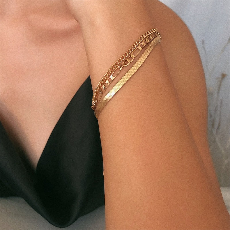 Three delicate chain bracelets in mixed link styles, stackable