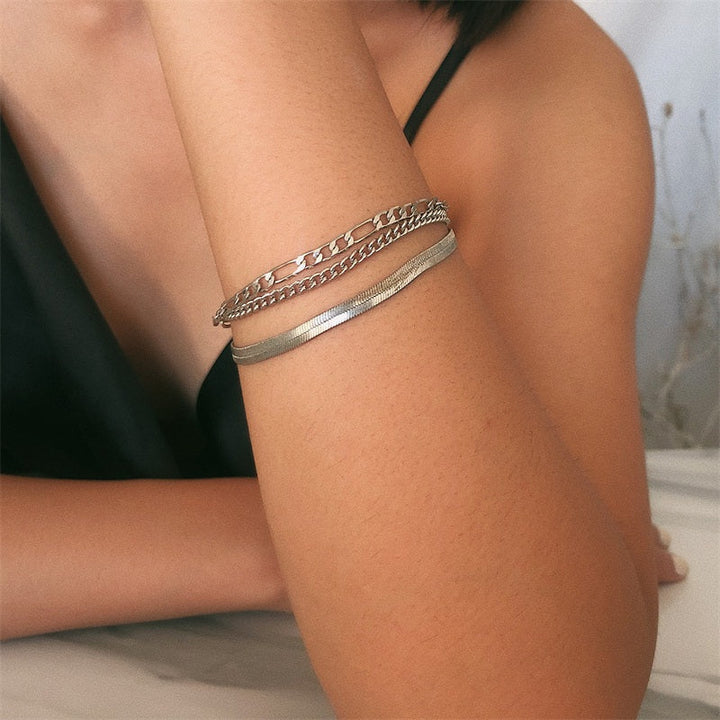 Three delicate chain bracelets in mixed link styles, stackable