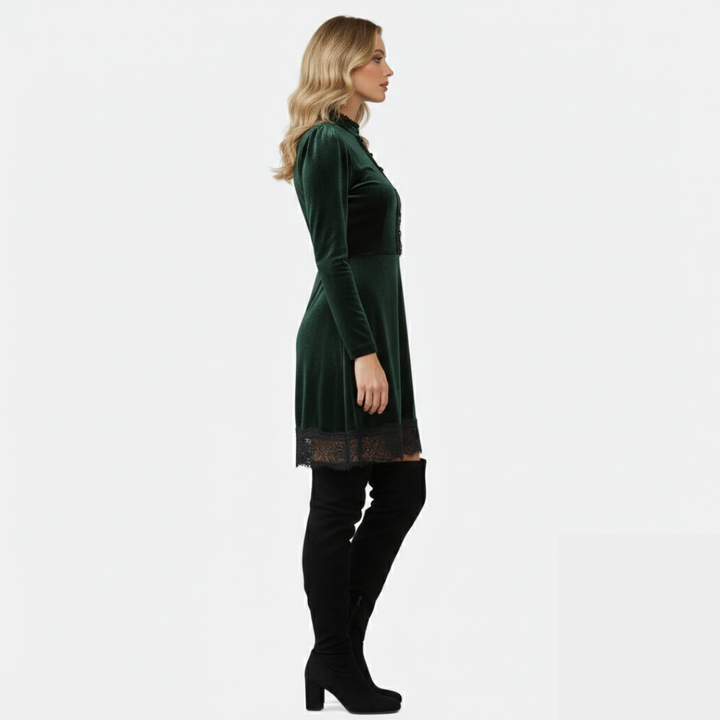 Women's over-the-knee boots with block heel and rounded toe in black suede, paired with a green velvet dress.