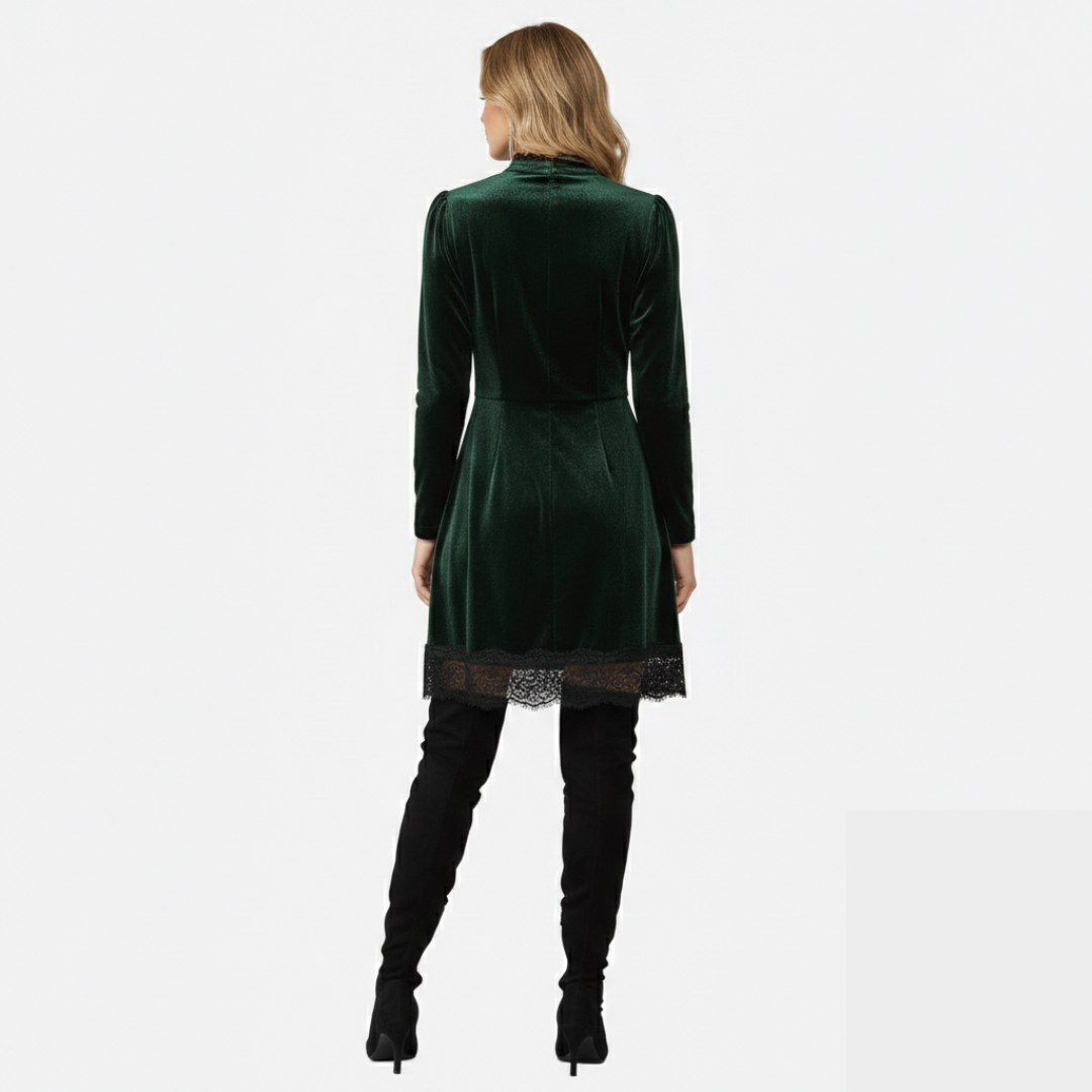 Women's over-the-knee boots with block heel and rounded toe in black suede, paired with a green velvet dress.