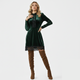 Women's over-the-knee boots with block heel and rounded toe in black suede, paired with a green velvet dress.