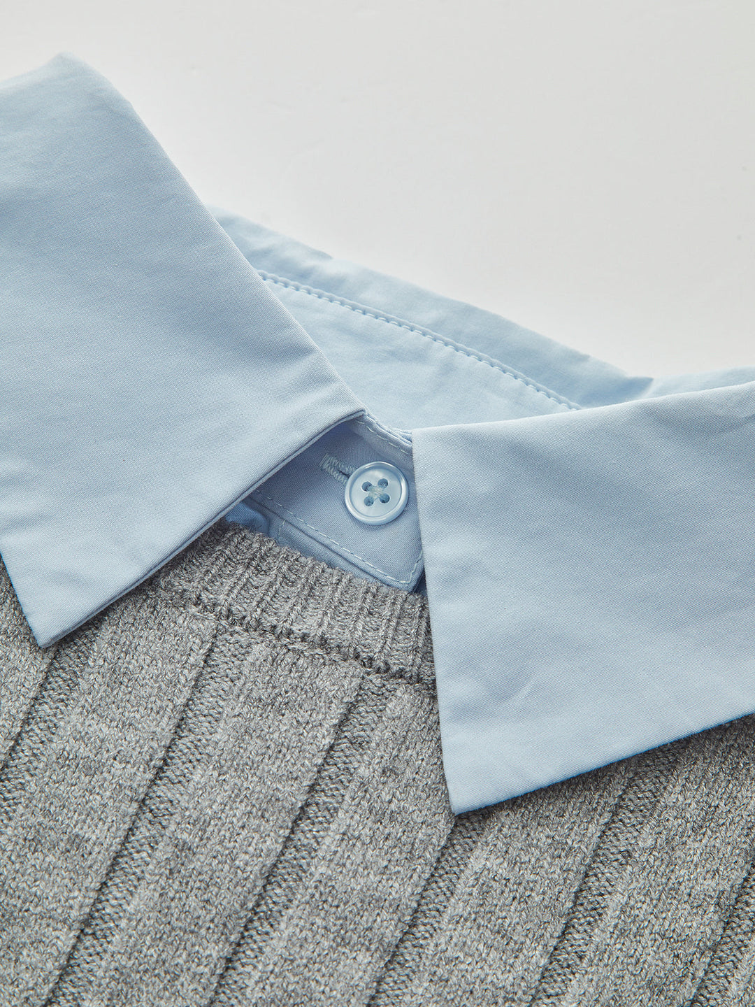 Women's grey ribbed long-sleeve top with collared blue shirt layer and front pockets