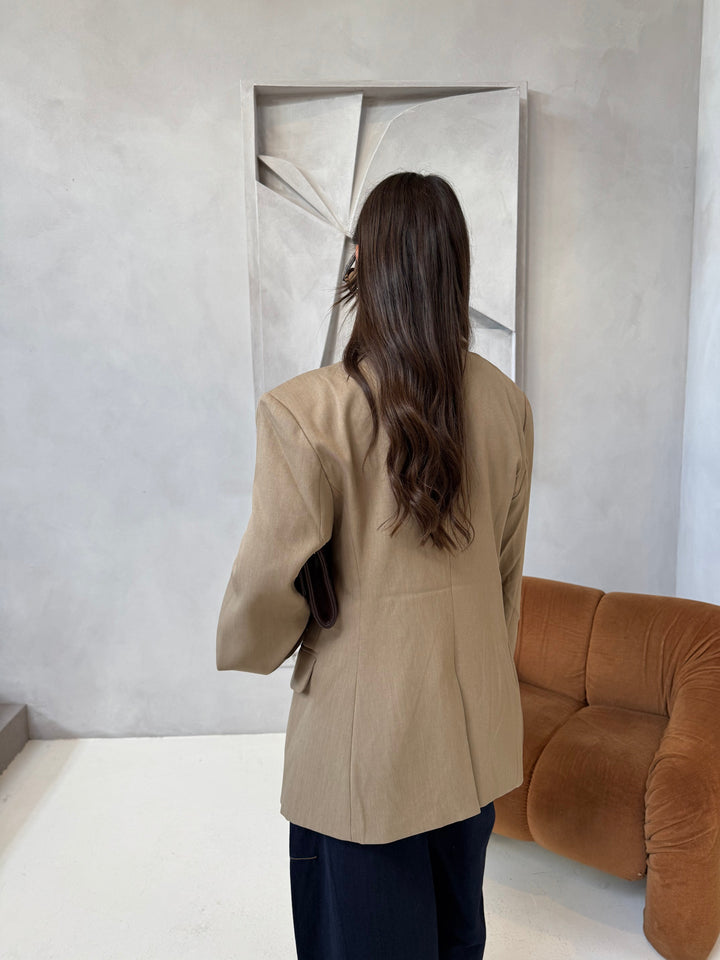 Women's beige blazer with notched lapels and button cuffs