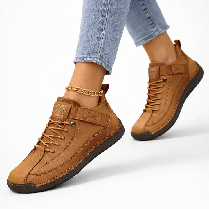 Women's low-top lace-up sneakers with stitched panels, strap detail and flat textured soles
