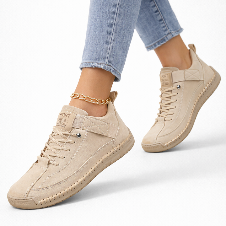 Women's low-top lace-up sneakers with stitched panels, strap detail and flat textured soles