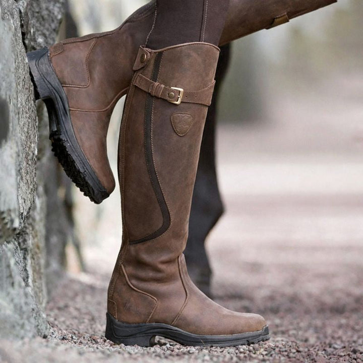 Women's knee-high boots with buckle strap, side zipper and lug sole