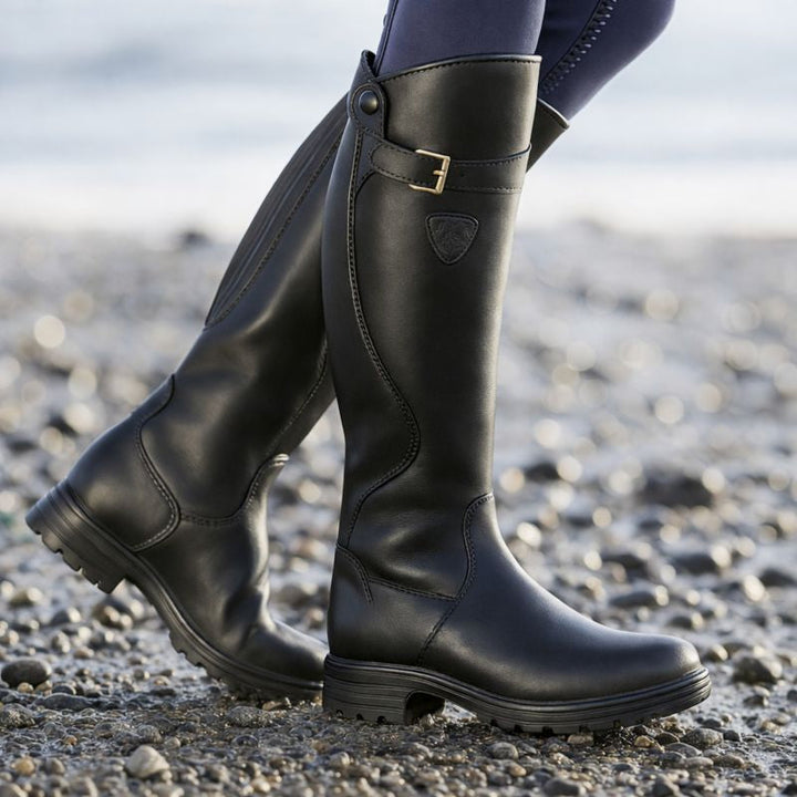 Women's knee-high boots with buckle strap, side zipper and lug sole