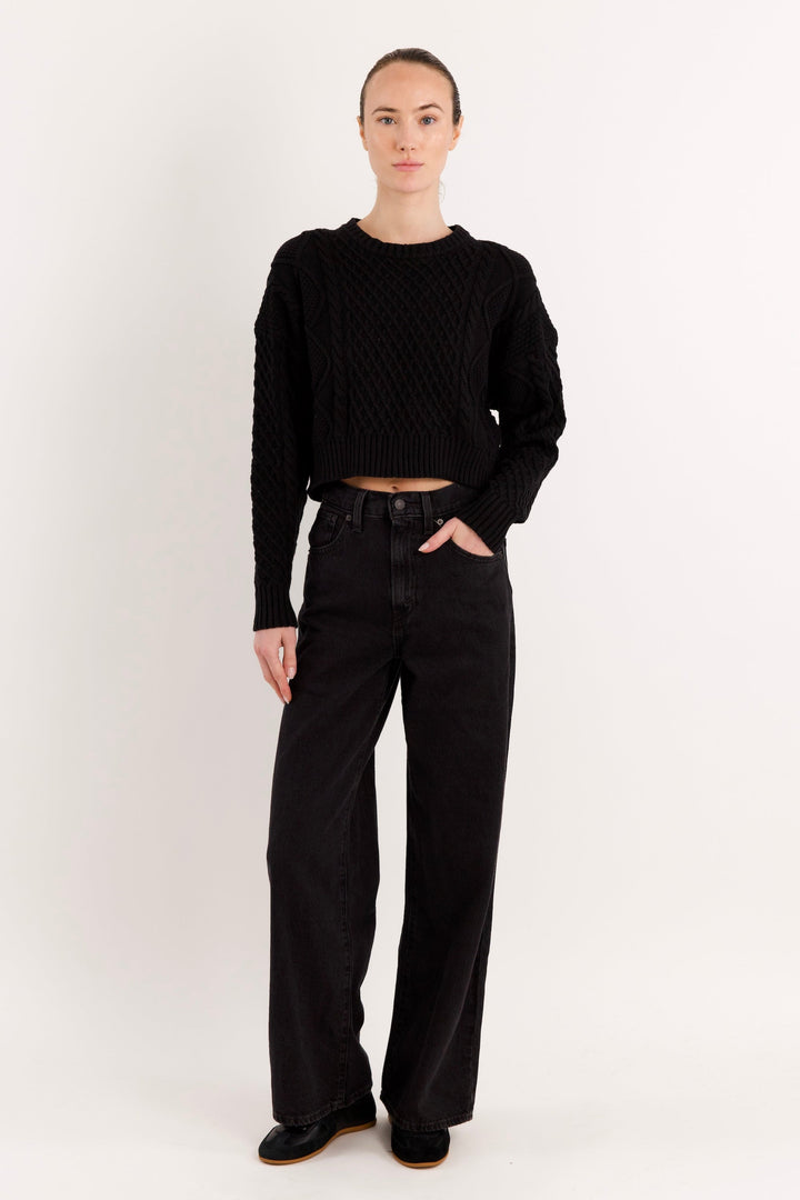 Women's cropped cable knit sweater with crew neckline and long sleeves