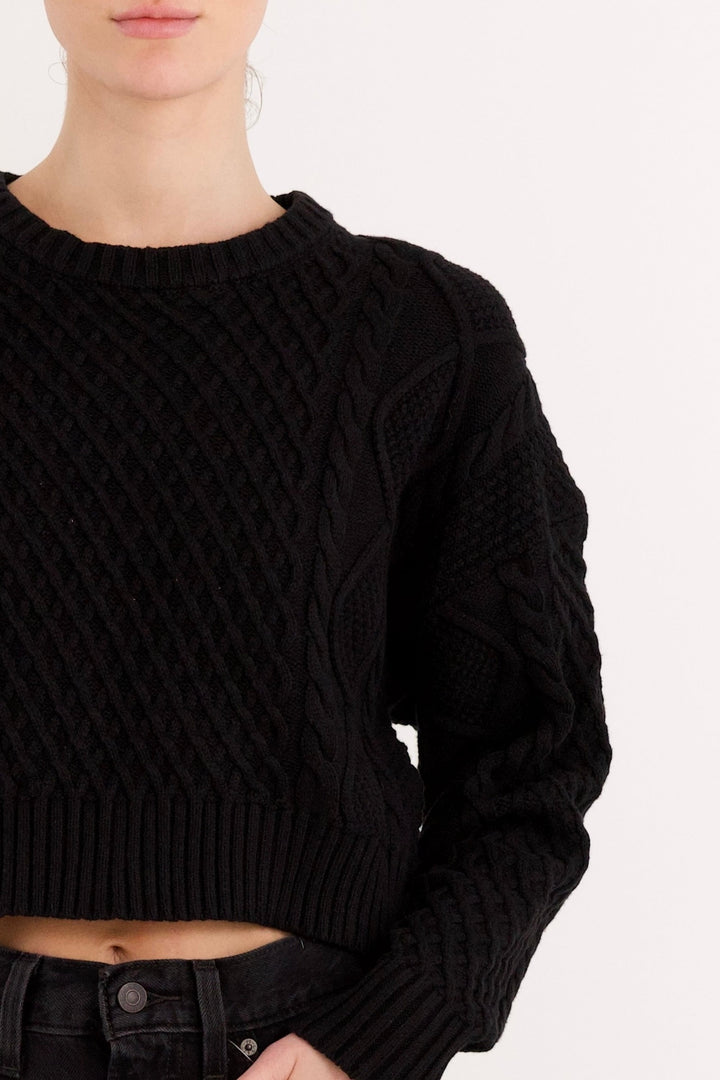 Women's cropped cable knit sweater with crew neckline and long sleeves