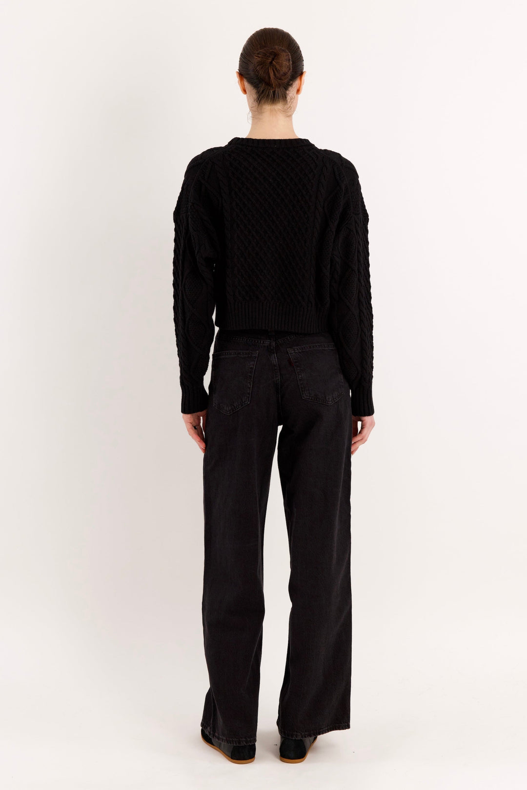 Women's cropped cable knit sweater with crew neckline and long sleeves