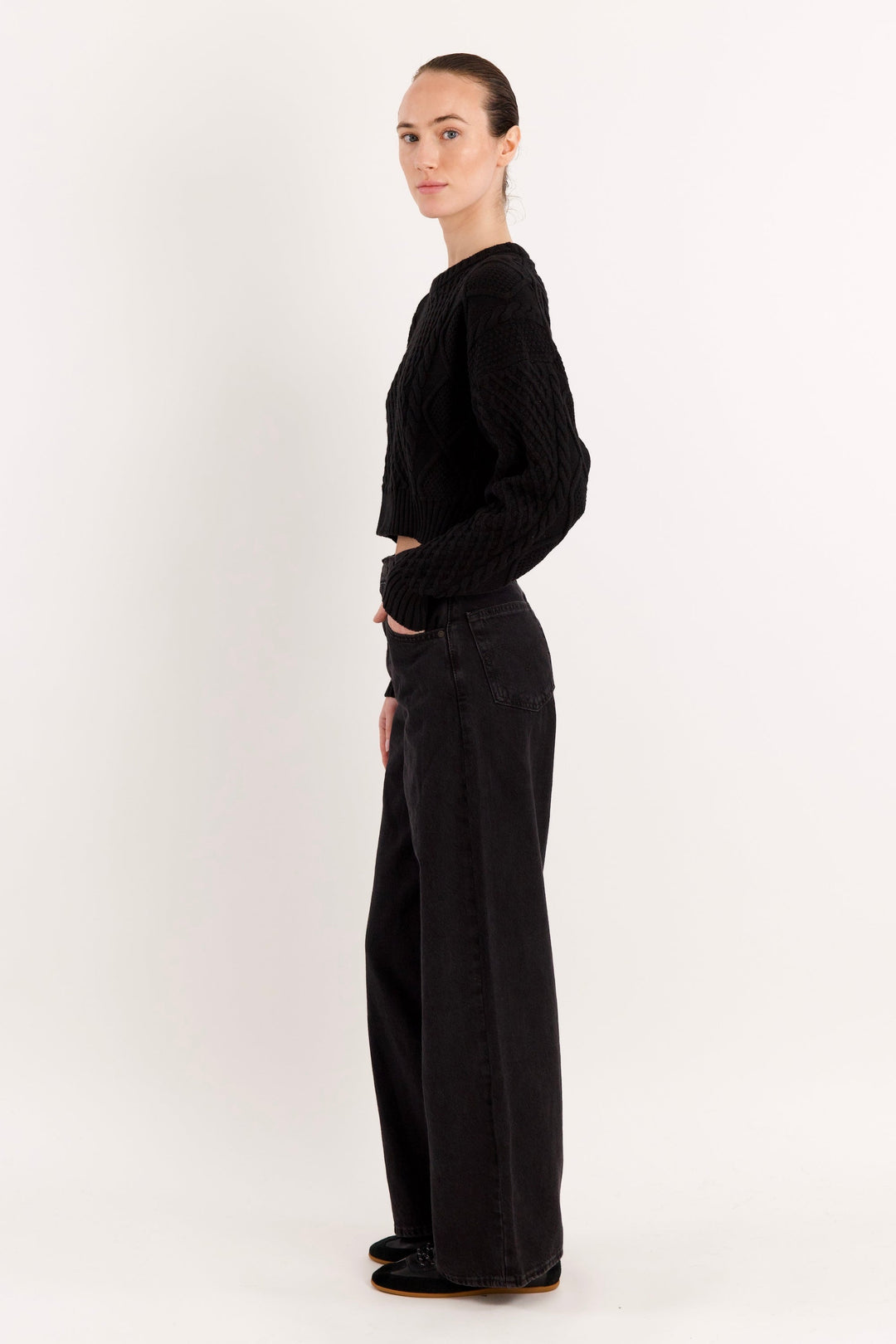 Women's cropped cable knit sweater with crew neckline and long sleeves