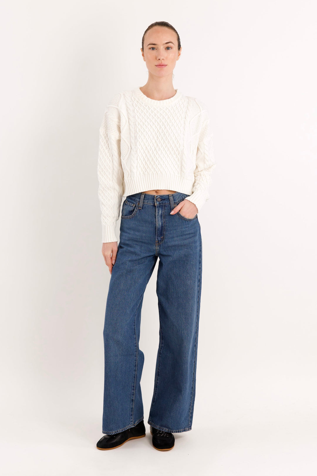 Women's cropped cable knit sweater with crew neckline and long sleeves