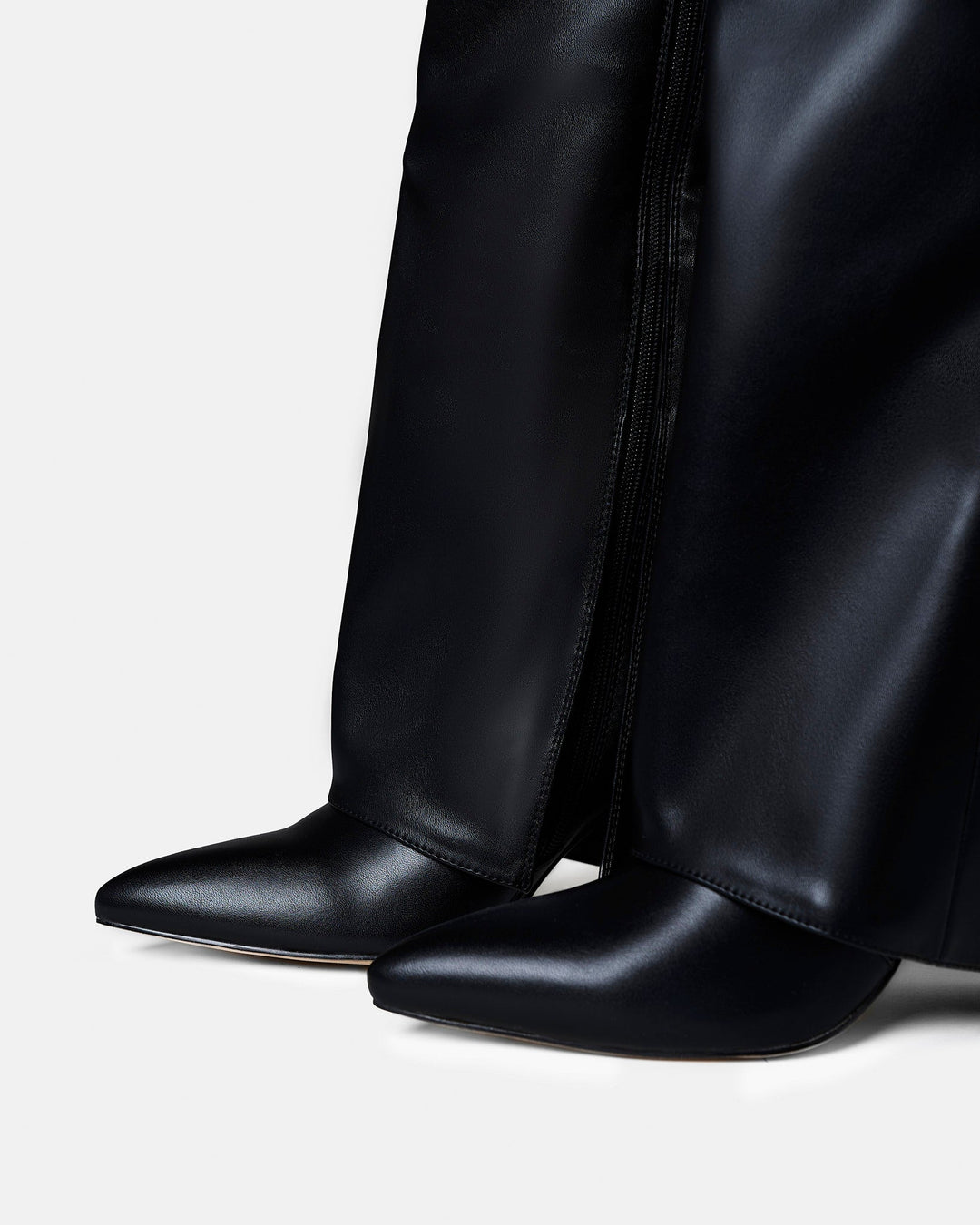 Women's black knee-high boots with pointed toes, low heels and buckle straps