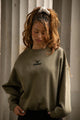 Women's green crewneck sweatshirt with tonal chest logo and ribbed trims
