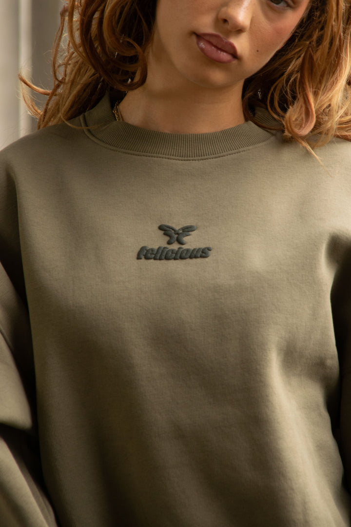 Women's green crewneck sweatshirt with tonal chest logo and ribbed trims