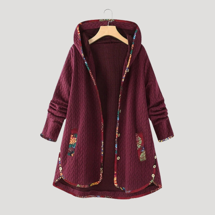 Women's long quilted hooded coat with patterned trim and front pockets