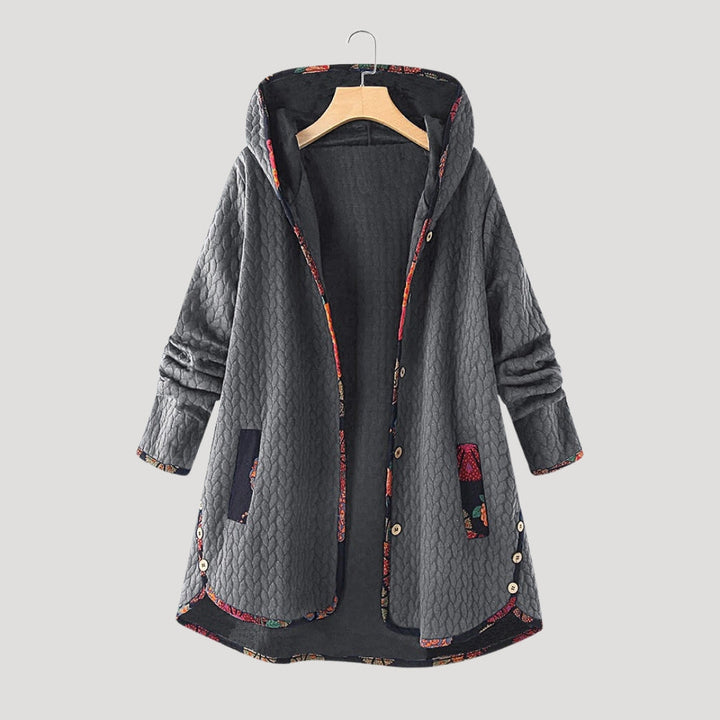 Women's long quilted hooded coat with patterned trim and front pockets