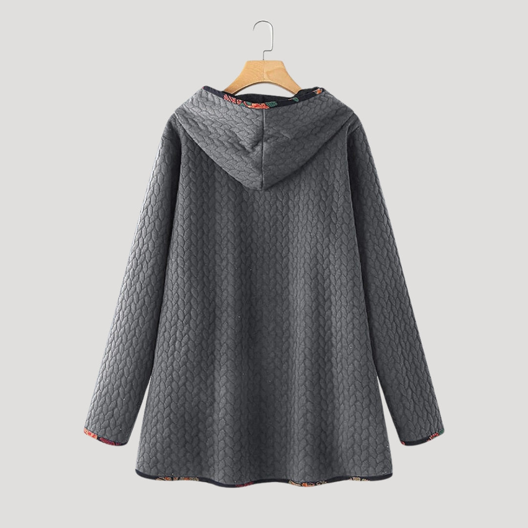 Women's long quilted hooded coat with patterned trim and front pockets