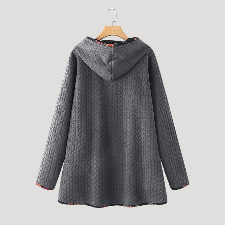 Women's long quilted hooded coat with patterned trim and front pockets