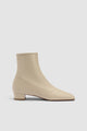 Women's beige pointed toe ankle boot with side zipper and low block heel
