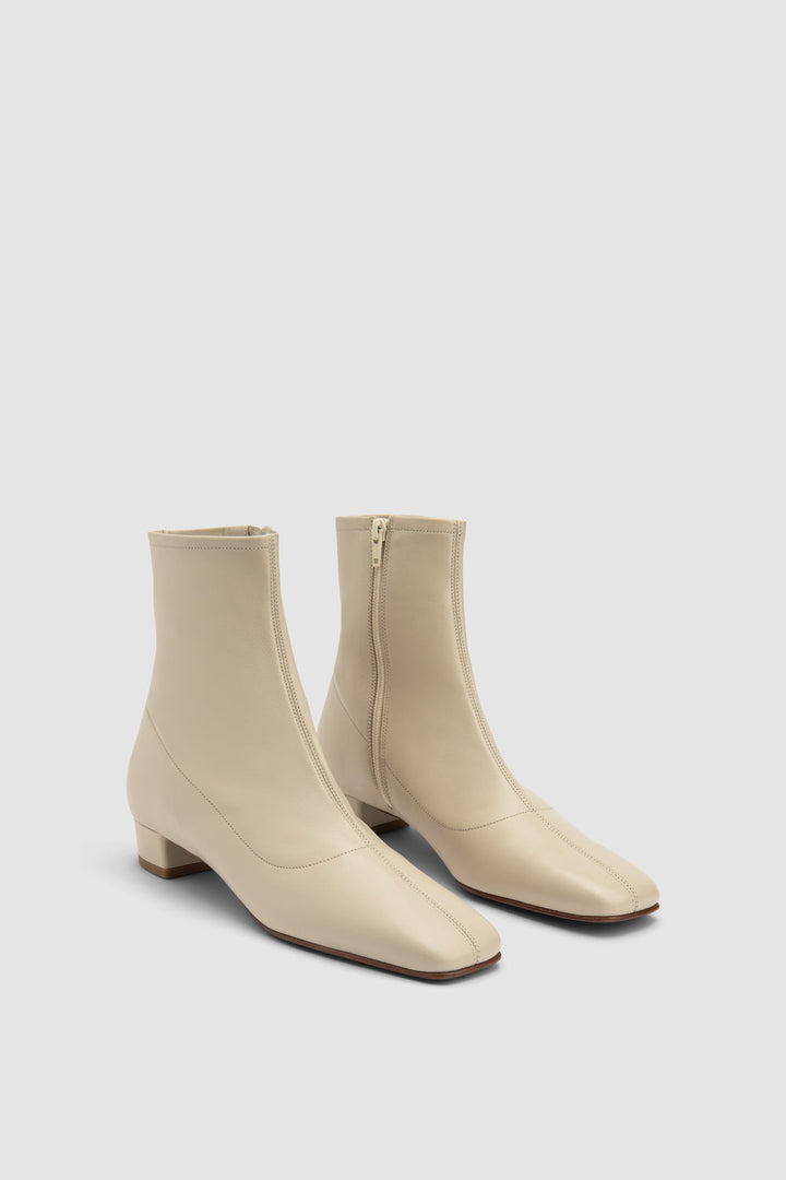 Women's beige pointed toe ankle boot with side zipper and low block heel