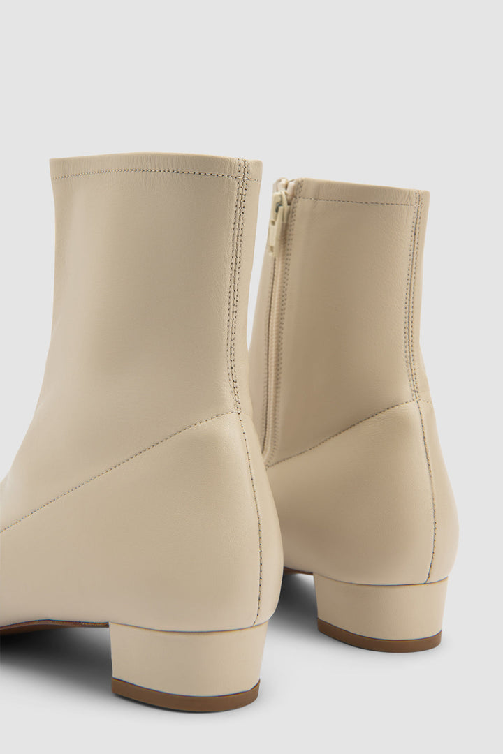 Women's beige pointed toe ankle boot with side zipper and low block heel