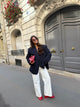 Women's navy blazer with notched lapels, long sleeves and button front