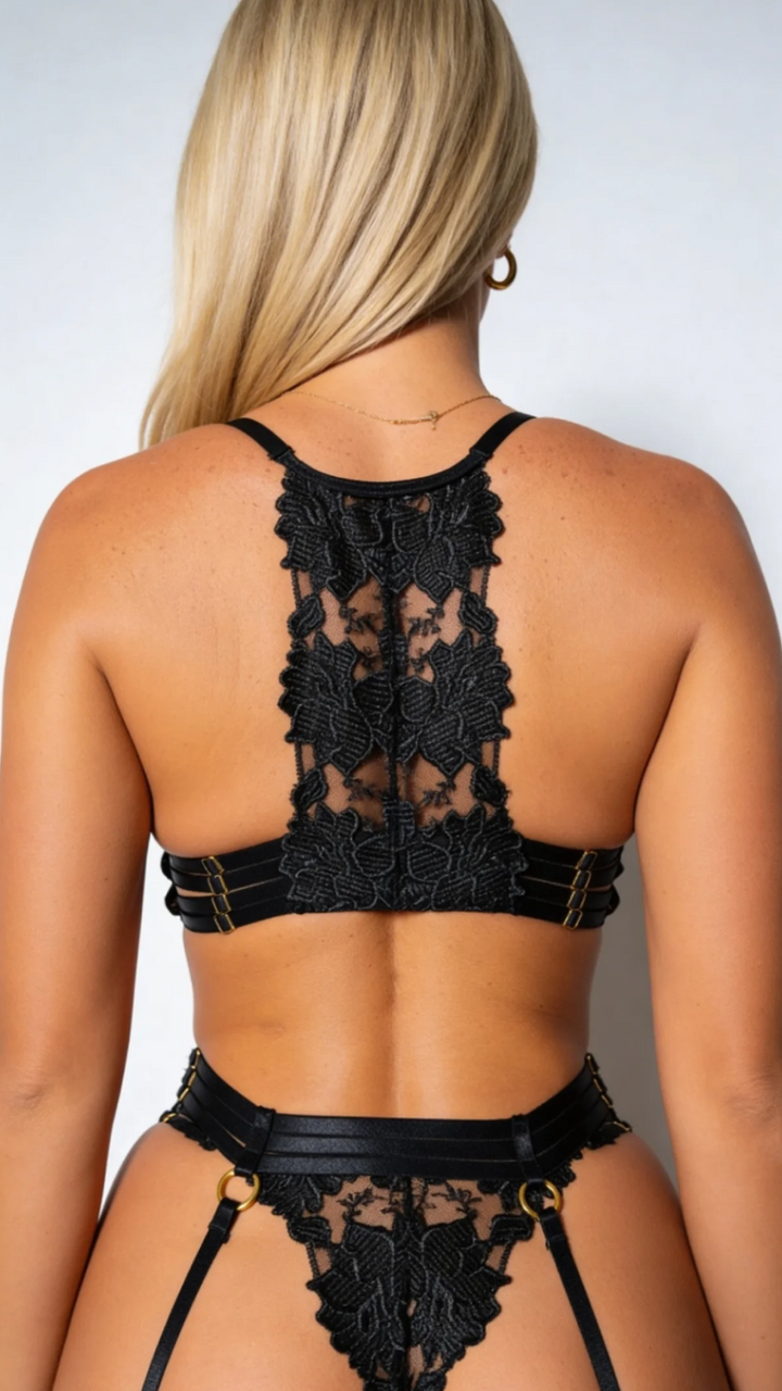 Women's black lace four-piece lingerie set with bra, briefs, garter belt and stockings