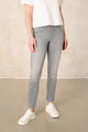 Women's grey slim fit jeans with a mid-rise waist and ankle-length legs