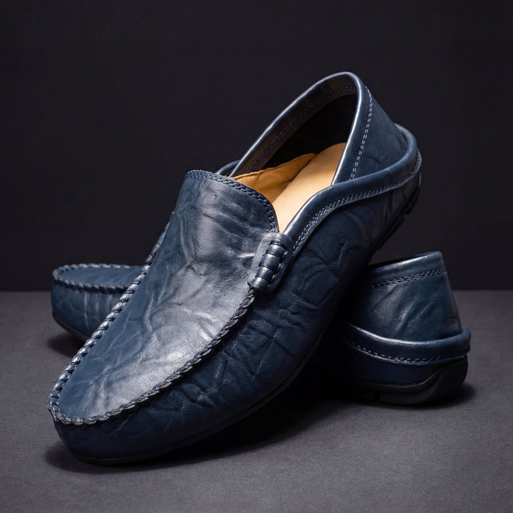 Slip-on moc toe loafers with stitched trim and layered vamp detail