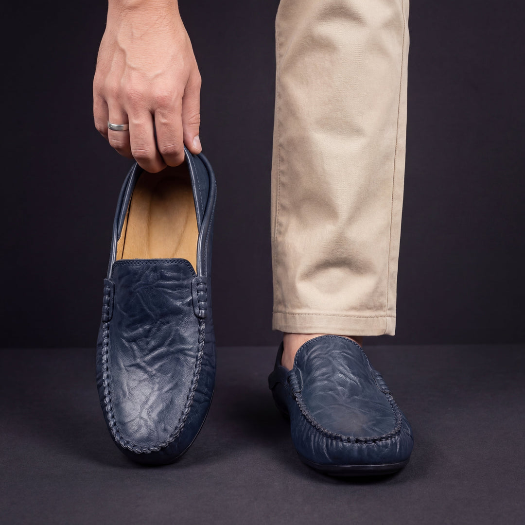 Slip-on moc toe loafers with stitched trim and layered vamp detail
