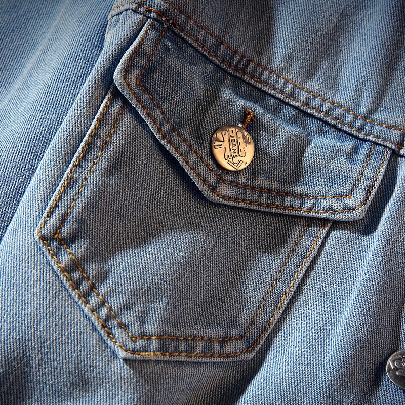Men's blue denim jacket with striped collar, button front and four flap pockets
