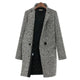 Women's black and white houndstooth long coat with notched lapels and button fastening