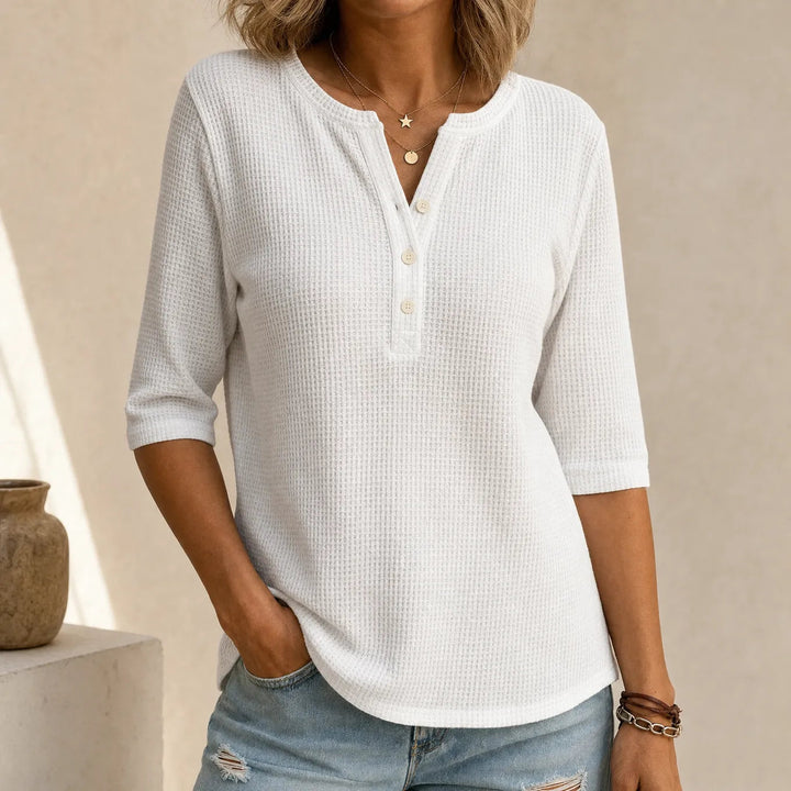 Women's waffle-textured Henley top with button placket and three-quarter sleeves